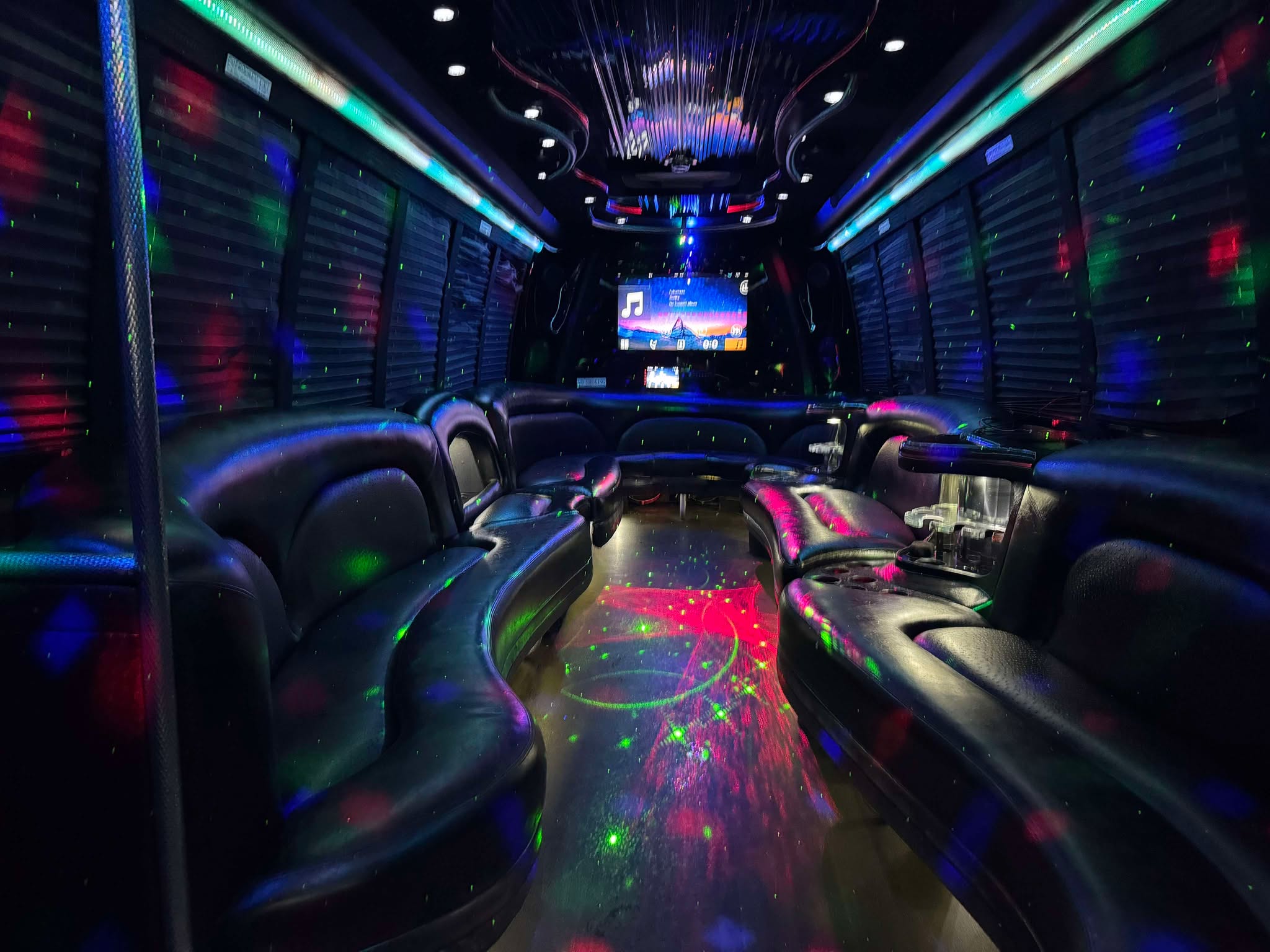 Luxury 28 Passenger Party Buses Rental in Atlanta near me featuring plush seating LED lighting and high quality sound systems for group celebrations.