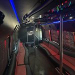 Luxurious 35-passenger party bus interior with custom lighting, comfortable seating, and entertainment features.