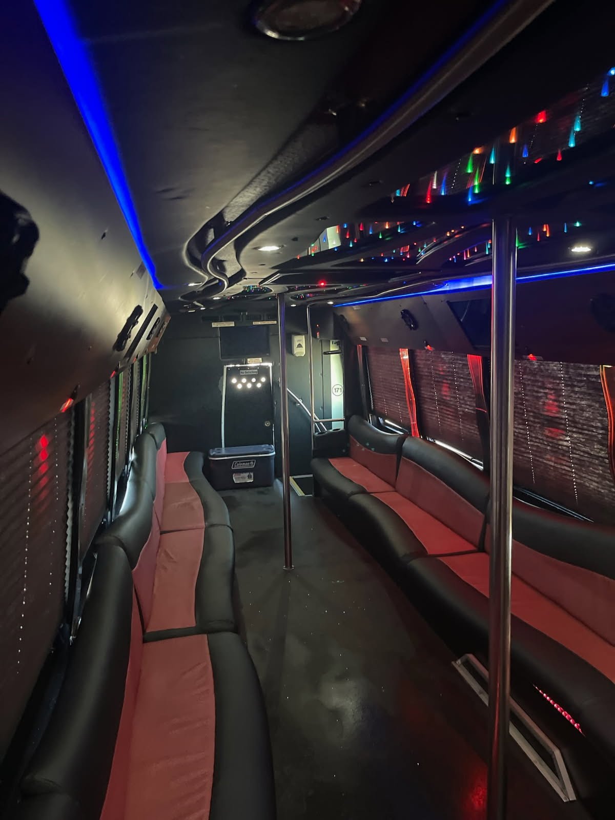 Luxurious 35-passenger party bus interior with custom lighting, comfortable seating, and entertainment features.