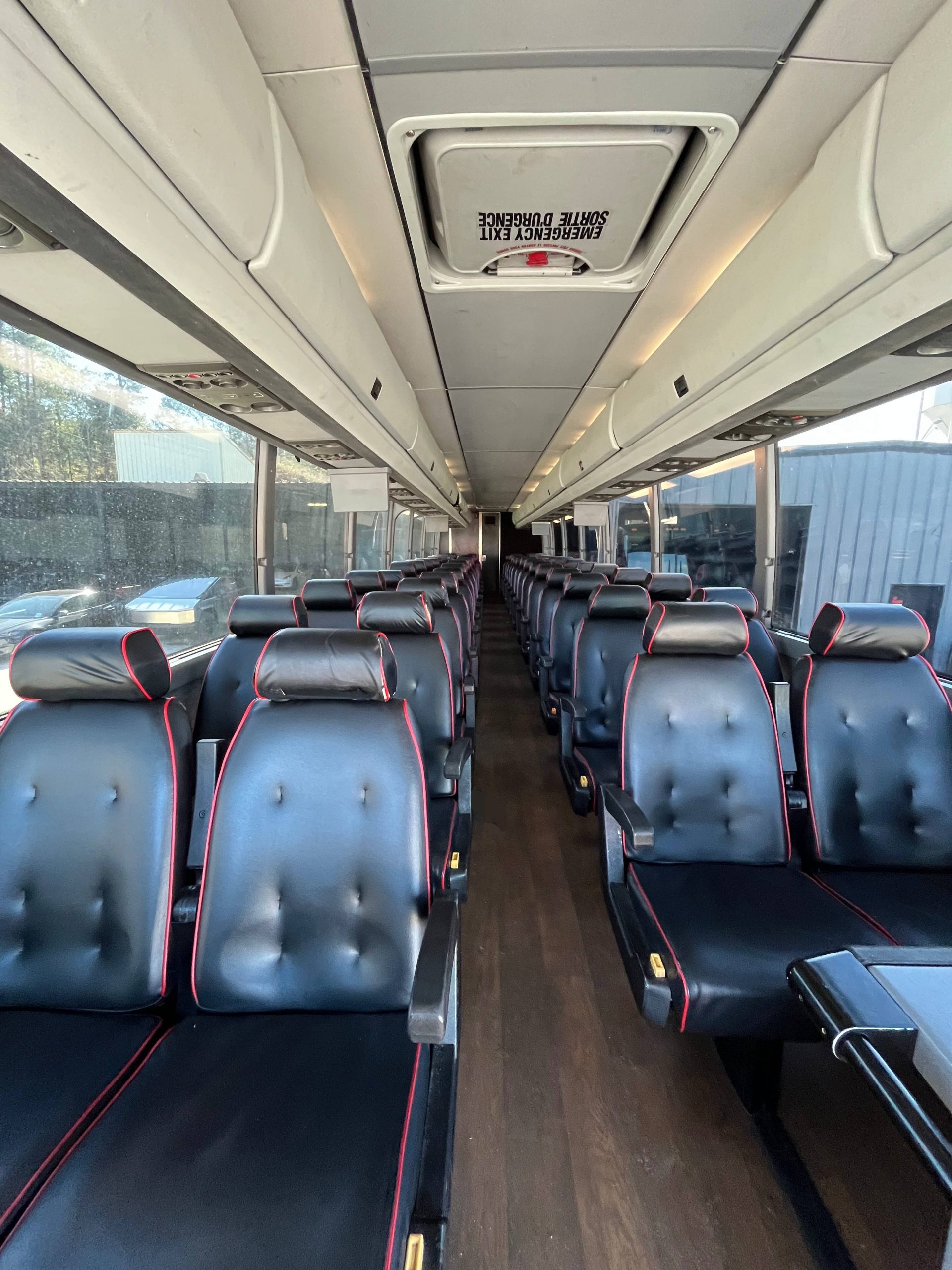 A modern, clean 56 passenger standard coach shuttle bus, perfect for large group transportation.